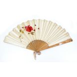A late 19th/early 20th century silk fan embroidered to one side with blossoming flower on wooden