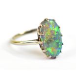 A white metal and black opal ring, the band stamped 18, approx 2.6g, size P.Additional