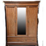 An Edwardian mahogany and inlaid dressing table with oval mirror above two short and two long