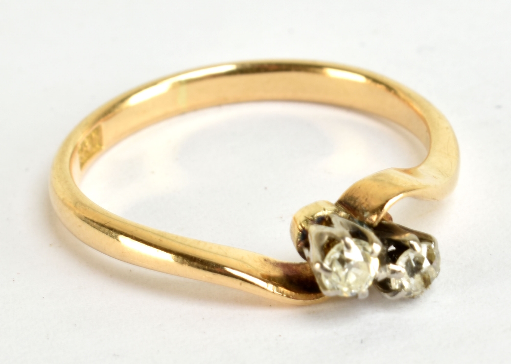 An 18ct yellow gold and old cut diamond two stone crossover ring, size P, approx 2.9g.Additional