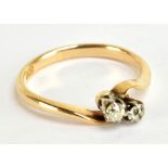 An 18ct yellow gold and old cut diamond two stone crossover ring, size P, approx 2.9g.Additional