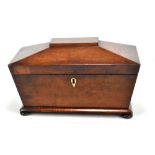A Victorian mahogany tea caddy of sarcophagus form, with three division interior retaining both lids
