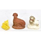 A 19th century brown glazed figure of a poodle, a Staffordshire poodle and a small yellow glazed