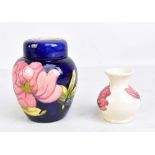 MOORCROFT; a tubeline decorated 'Magnolia' pattern lidded ginger jar on navy ground, height 15cm,