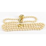 VENDOME; a double strand of faux pearls, with a gold tone and diamante clasp, length approx 36cm,