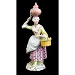 MEISSEN; a mid-18th century figure of an egg seller modelled by Reincike and designed by Christopher