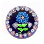 ATTRIUBUTED TO PAUL Y'SART; a glass paperweight with single flower inset within Millefiori
