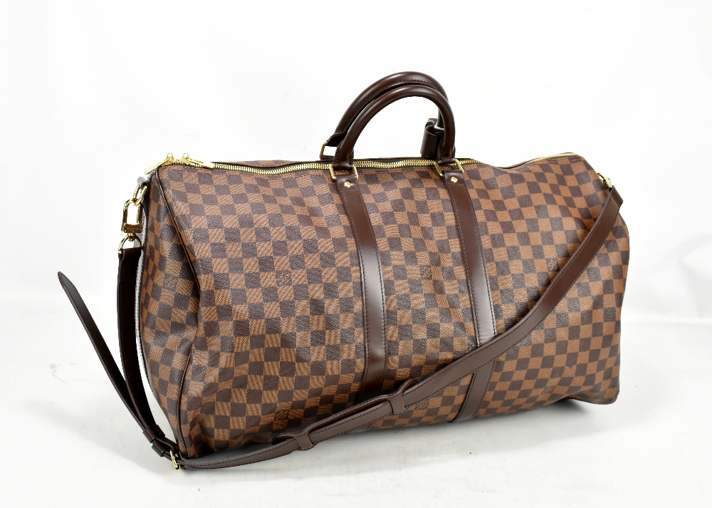 LOUIS VUITTON; a Keepall Bandouliere 55 Monogram macassar Boston bag, with brown leather straps a