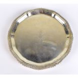 A George VI hallmarked silver waiter, with shaped rim and three scrolling supports, with