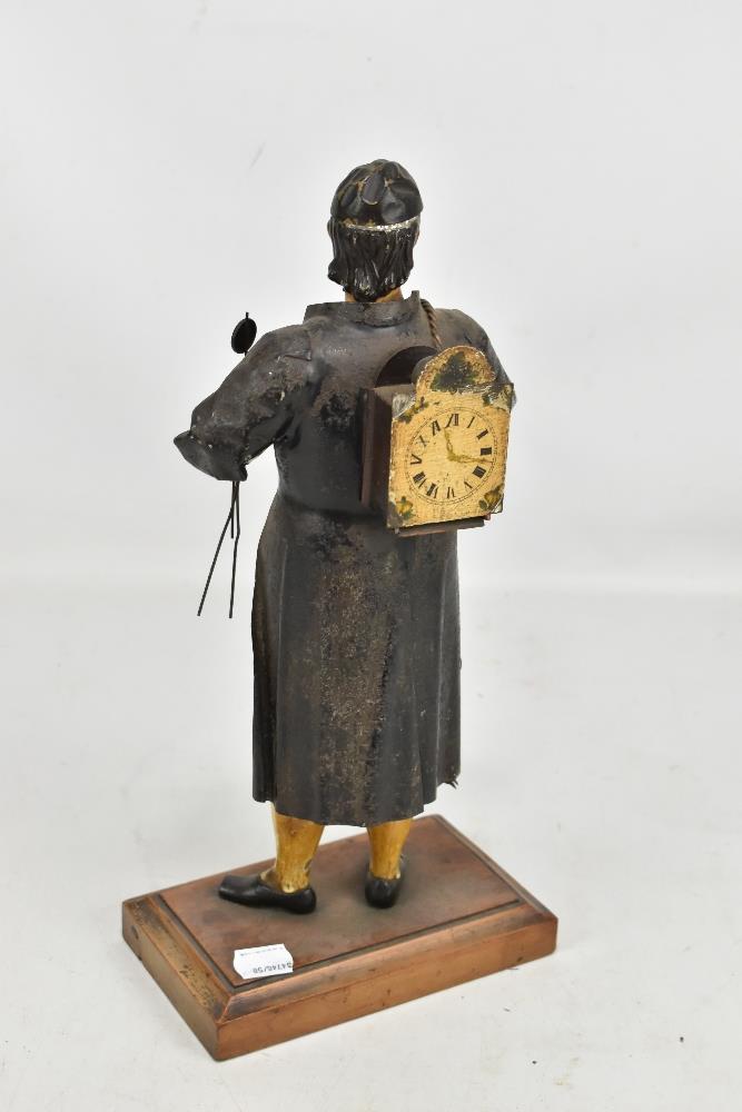 A late 19th century tole ware painted tin mantle time piece modelled as a clock salesman with wall - Image 2 of 3