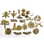 A collection of cap badges, titles, buttons and silks, including Machine Gun Corps, Manchester