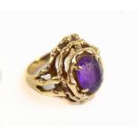 A yellow metal amethyst dress ring with openwork setting, stamped 9ct, approx 8g, size K.