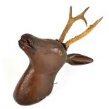 An early 19th century Austrian carved wooden deer head set with three point antlers, height approx