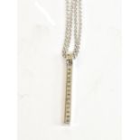 An 18ct white gold diamond set rectangular pendant with sixteen round brilliant cut stones on an