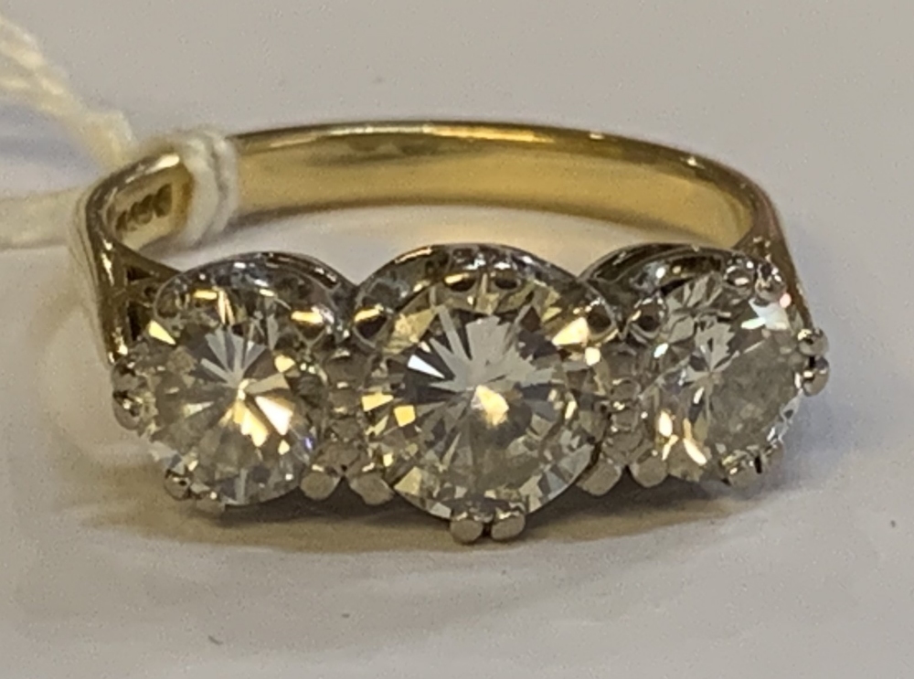 An 18ct yellow gold and diamond three stone ring, the central round brilliant cut stone weighing - Image 3 of 8
