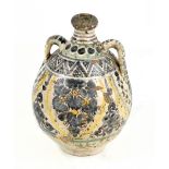 A 17th century Sicilian maiolica jar, probably Caltagirone, with folded rim above twin lug handles