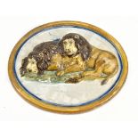 An early 19th century Prattware plaque relief moulded with a pair of recumbent lions, unmarked,