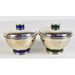PUIFORCAT; a pair of Art Deco silver plated circular boxes and covers, one with bands of green