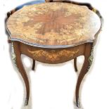 An early 20th century Continental mahogany inlaid centre table with shaped circular top and gilt