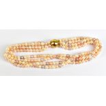 LANGER; a four strand fresh water pink pearl necklace with magnetic Langer clasp.Additional