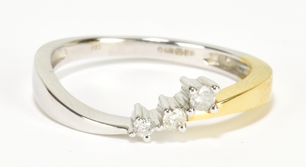 A 9ct yellow and white gold three stone diamond ring, size M, approx 2g.