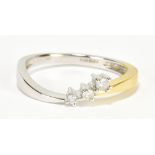 A 9ct yellow and white gold three stone diamond ring, size M, approx 2g.