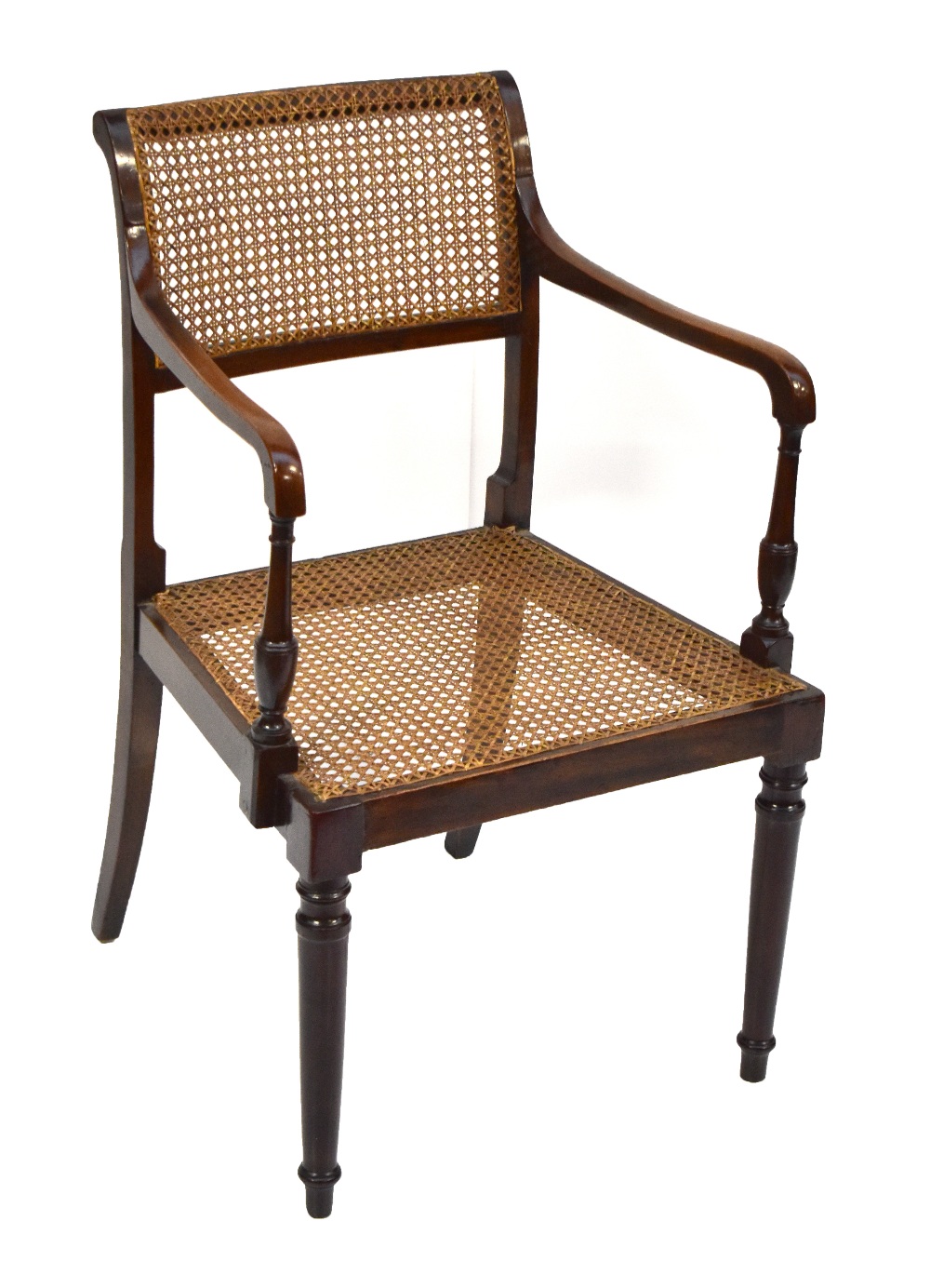 An early 20th century caned armchair.