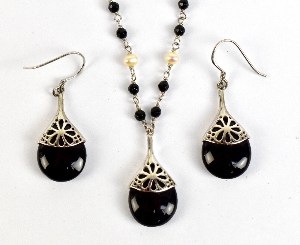 A white metal black bead and pearl necklace stamped 925, and a pair of matching drop earrings.