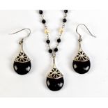 A white metal black bead and pearl necklace stamped 925, and a pair of matching drop earrings.