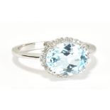 A 9ct white gold aquamarine and diamond ring, the oval aquamarine weighing approx 3cts within a
