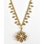 A yellow metal and seed pearl necklace, with detachable floral pendant/brooch in the form of a