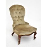 A Victorian button back nursing chair of serpentine outline in pale green upholstery, on cabriole