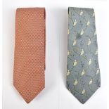 HERMÉS; two silk ties, the first a cream, gold and blue chain pattern (no. 7788), the second black