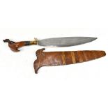 A Philippines barong dagger with carved hilt, blade length 36cm, in wooded scabbard.Additional