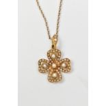 A 15ct yellow gold four leaf clover pendant set with cut pearls, suspended on a fine link chain,