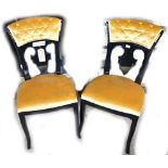 A pair of black painted velvet upholstered side chairs with square sectioned outsplayed front legs.