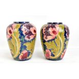 FREDERICK RHEAD FOR BURSLEY WARE; a near pair of 'Seed Poppy' tubeline decorated ovoid vases,