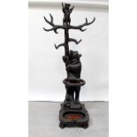 A reproduction Black Forest style oak carved hall stand in the form of a bear grasping a tree,