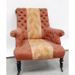 A Victorian button-back fireside chair upholstered in a pink woven material,