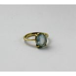 An 18ct gold dress ring set with a very pale blue stone, size I, approx 2g.