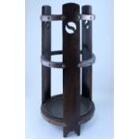 An Arts & Crafts oak umbrella stand with stylised rose motif and copper banding, circular drip tray,