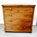 A Victorian mahogany chest of two short over three long drawers, with turned wooden handles,