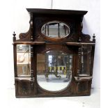 An Edwardian mahogany overmantel mirror carved with turned uprights,