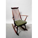 An Ercol dark stained stick-back rocking chair with label to seat.