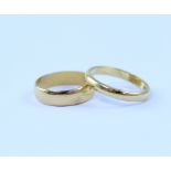 Two 22ct yellow gold band rings, combined approx 5.8g (2).