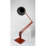 A 20th century painted orange Anglepoise lamp, stamped 'The Anglepoise Patented in UK and Abroad'.