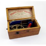 A mahogany-cased magneto-electric shock therapy machine, original label inside, length 20cm.