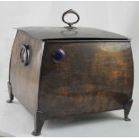 An Arts & Crafts style copper finish coal scuttle raised on four supports with blue hardstone