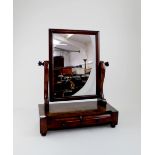 A Victorian mahogany toilet mirror with scrolling supports and two base drawers, raised on bun feet,