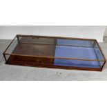 A mahogany and glazed long tabletop display cabinet,